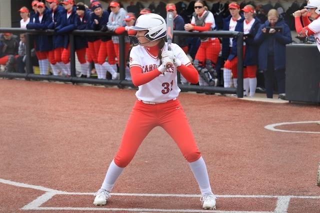 An SVSU softball player in a white jersey prepares to hit. 