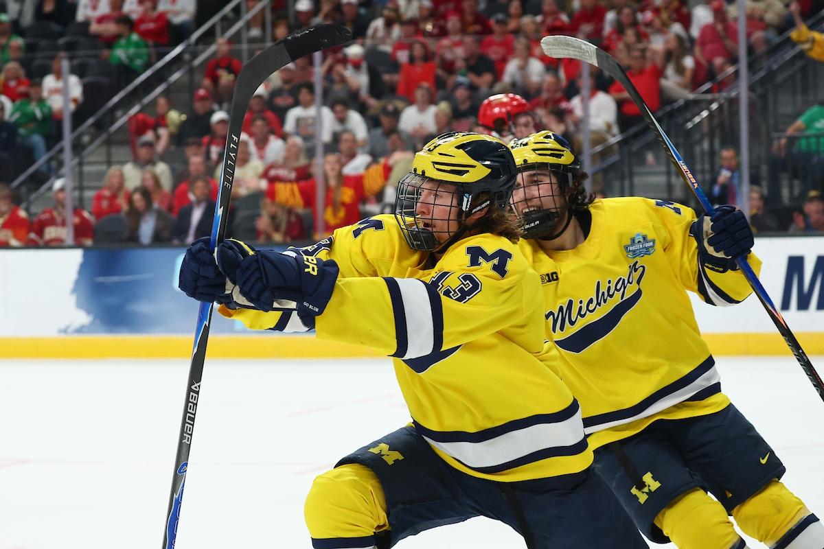 Michigan's T.J. Hughes celebrates a first period goal against Denver in the Frozen Four